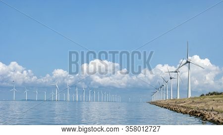 Wind Turbine From Aerial View, Drone View At Windpark Westermeerdijk A Windmill Farm In The Lake Ijs