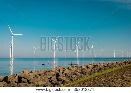 Wind Turbine From Aerial View, Drone View At Windpark Westermeerdijk A Windmill Farm In The Lake Ijs