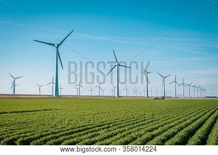 Wind Turbine From Aerial View, Drone View At Windpark Westermeerdijk A Windmill Farm In The Lake Ijs
