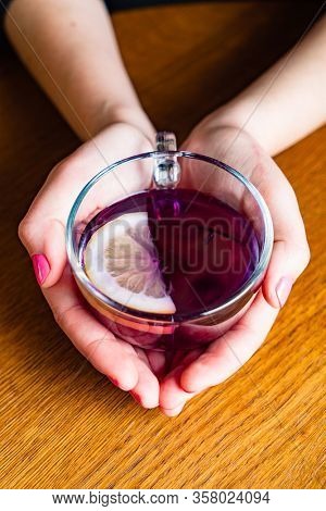 woman drinking Blue Butterfly Pea Tea