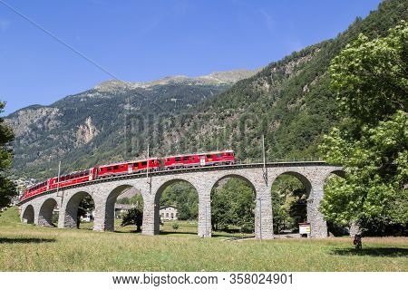 Brusio, Switzerland: 26 August 2018 - Bernina Express Train Is Going Through The Famous Circular Via