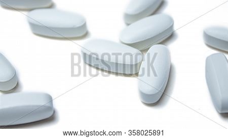 Tablets. Pills Background. Pills And Tablets In White On A White Background. Macro. Copy Space