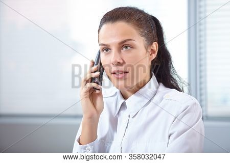 businesswoman with mobile phone in offece