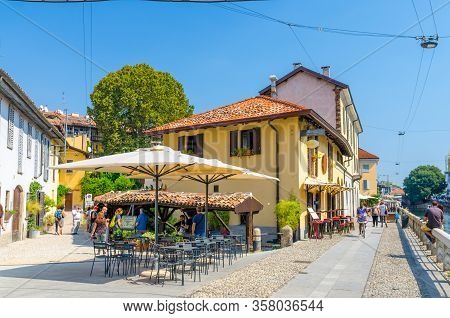 Milan, Italy, September 9, 2018: Old Yellow Building Vicolo Lavandai With Tiled Roof And Parasols Ne