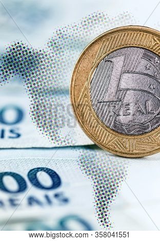 Details Of 100 Reais , And One Real Coin, Banknote From Brazil, With Selective Focus, Background Ima
