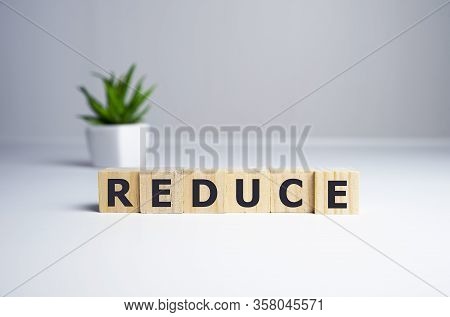 Reduce Word Written On Wood Block. Reduce, Reuse And Recycle Text On Wooden Table For Your Desing, C