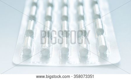 Blister Of Pills Closeup In The Center. Background Or Texture About Medicine, Health, Vitamins Which