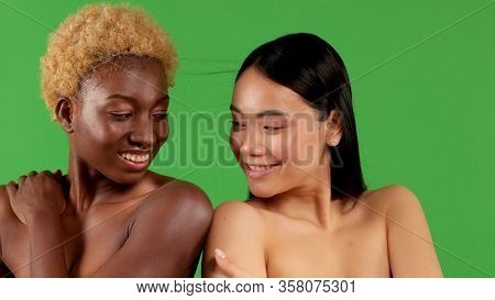 Attractive Portrait Of Beautiful Black Woman And Woman Of Asian Appearance Posing In Studio With Bar