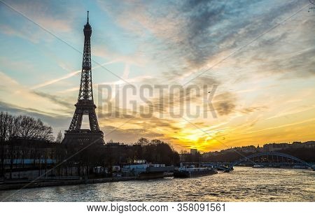 View On The Famous Paris Eiffel Tower From The Promenade Of The Seine At Night .