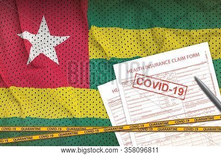 Togo Flag And Health Insurance Claim Form With Covid-19 Stamp. Coronavirus Or 2019-ncov Virus Concep
