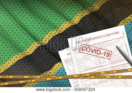 Tanzania Flag And Health Insurance Claim Form With Covid-19 Stamp. Coronavirus Or 2019-ncov Virus Co