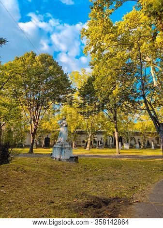 Old Grave With A Monument To A Famous Person In The Cemetery. Architectural Stone Statue, Old Histor