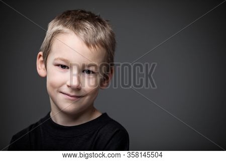 Grief-stricken little boy - feeling intense sorrow, remorse, sadnesss - studio portrait - vivid emotions series