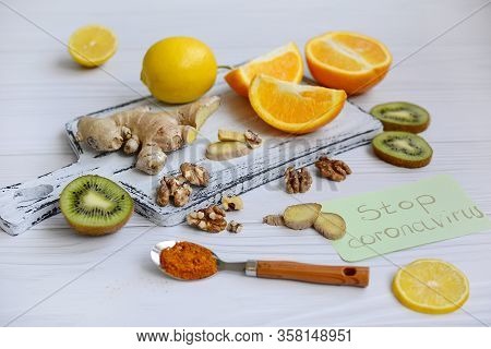 Food To Boost Immunity To Fight Coronavirus. Citruses, Ginger, Turmeric, Kiwi, Walnuts On A Light Wo