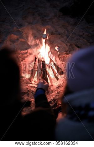Winter Picnic On Baech With Bonfire. Love Story On Winter Foggy Sand Beach. Fry Marshmallows At The 