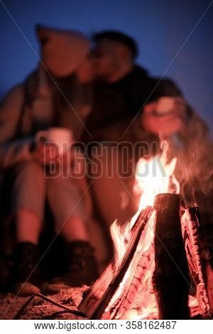 Winter Picnic On Baech With Bonfire. Love Story On Winter Foggy Sand Beach. Drink Hot Tea In Cold We