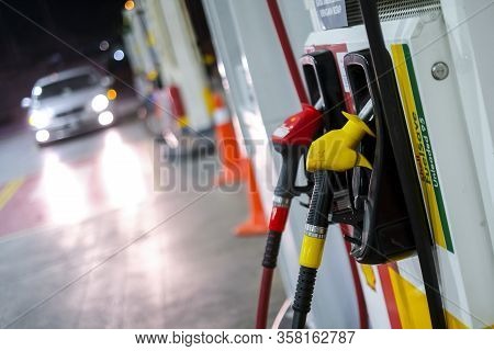 Petrol Pump Filling Nozzles At Shell Gas Station