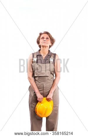Happy senior woman holding a safety hat (isolated on white)