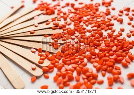 Orange Waxing With Wooden Sticks On The White Background