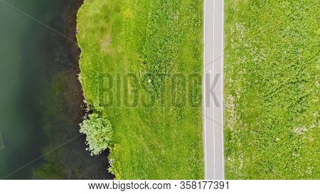 Aerial Flight Above The Path Along The Lake With Shifty On Her People.
