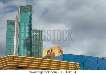 Shanghai, China - May 4, 2010: Green Glass Highrise Buildings Over Yellow And Blue Lower Mall, Conve