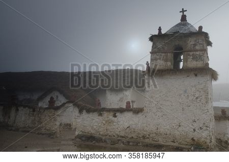 Church of Parinacota in a fog. Lauca National Park. Arica y Parinacota Region. Chile.