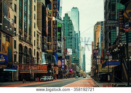 NEW YORK, USA - MARCH 21, 2020: Empty 42nd street with few pedestrians and traffic as the result of COVID-19 coronavirus pandemic outbreak in New York City.