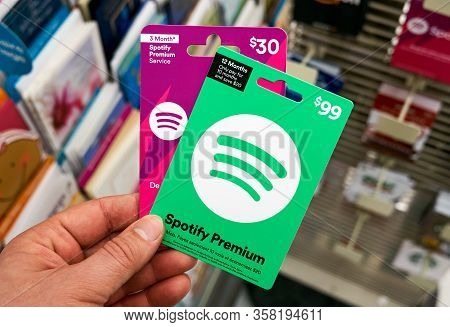 Montreal, Canada - March 24, 2020: Spotify Green Gift Card In A Hand At Store Over Gift Cards. Spoti