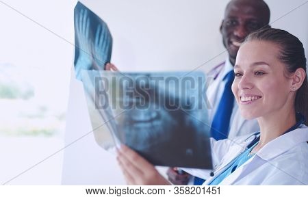 Doctors analyzing an x-ray in a meting. Doctors