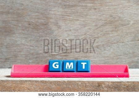 Tile Letter On Red Rack In Word Gmt (abbreviation Of Greenwich Mean Time) On Wood Background