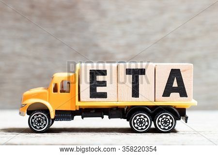 Truck Hold Letter Block In Word Eta (abbreviation Of Estimated Time Of Arrival) On Wood Background