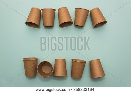 Many Craft Paper Cups For Coffee Or Any Drinks On A  Blue Paper Background. Concept Of Ziro Waste, N