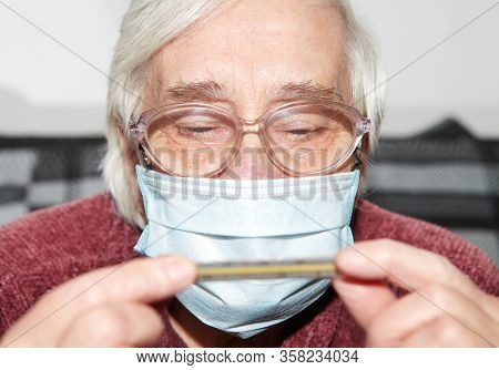Elderly Woman In A Medical Mask. The Epidemic