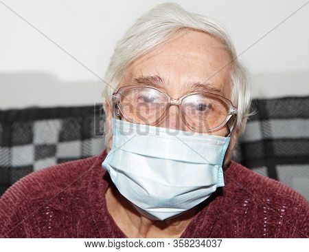 Elderly Woman In A Medical Mask