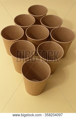 Many craft paper cups for coffee or any drinks on a  blue paper background. Concept of ziro waste, n