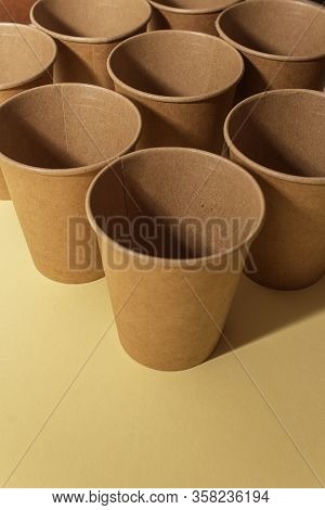 Many craft paper cups for coffee or any drinks on a  blue paper background. Concept of ziro waste, n