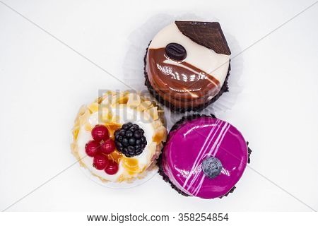 Three Cakes On A White Background:coffee Cake With A Grain Of Coffee, Chocolate, Cream Cake With Alm