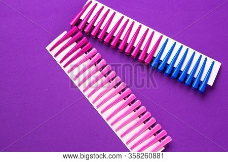 On A Purple Background Hair Clips Of Different Colors In Sets On A Cardboard Frame