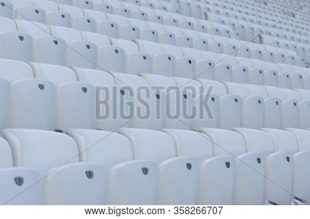 Empty White Seats In The Stadium Before The Match.
