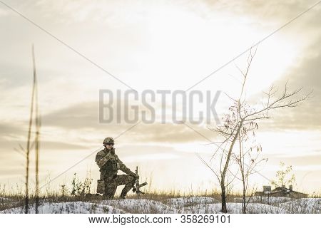 Modern War Soldier Army Man In The Winter Multicam Camouflage Is Patrolling Or Patrol Field Territor