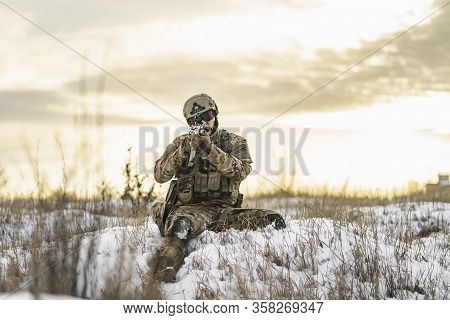 Modern War Soldier Army Man In The Winter Multicam Camouflage Is Patrolling Or Patrol Field Territor