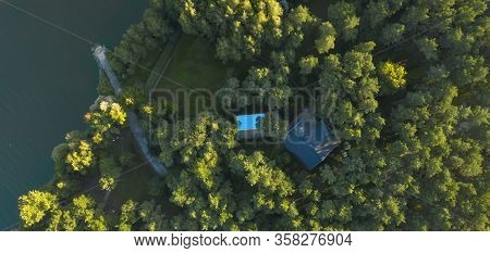 Top View Of A Mysterious Forest House With A Pool In A Forest Thicket
