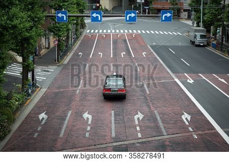 A Taxi Under Traffic Signs In Tokyo