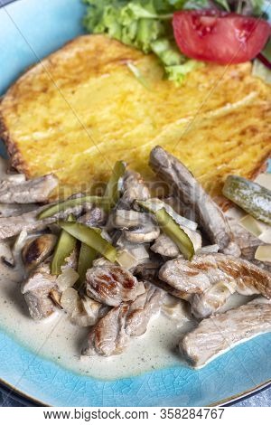 Overview Of Boeuf Stroganoff On A Blue, Plate