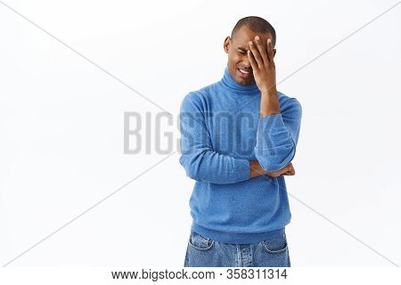 Portrait Of Distressed, Sad Young Grieving African-american Man Facepalm, Sobbing And Grimacing As F