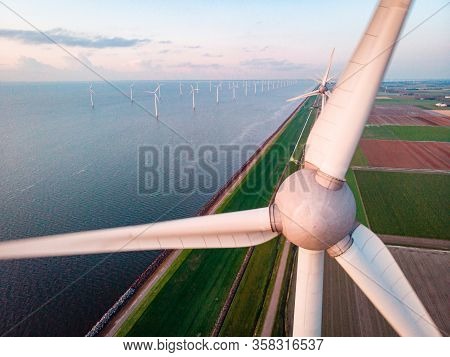 Wind Turbine From Aerial View, Drone View At Windpark Westermeerdijk A Windmill Farm In The Lake Ijs