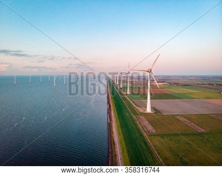Wind Turbine From Aerial View, Drone View At Windpark Westermeerdijk A Windmill Farm In The Lake Ijs