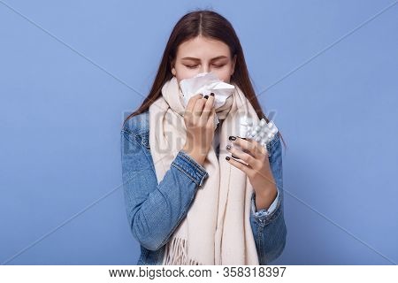 Picture Of Ill Isolated Brunette Blowing Her Nose, Holding Paper Napkin, Using Nasal Drops, Closing 