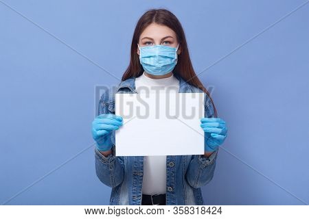 Image Of Good Looking Brunette Looking Directly At Camera, Holding Blank Sheet Of Paper, Wearing Ant