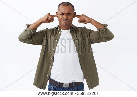 Portrait Of Annoyed, Stressed African-american Man Shut Ears, Grimacing And Pouting, Bothered By Lou
